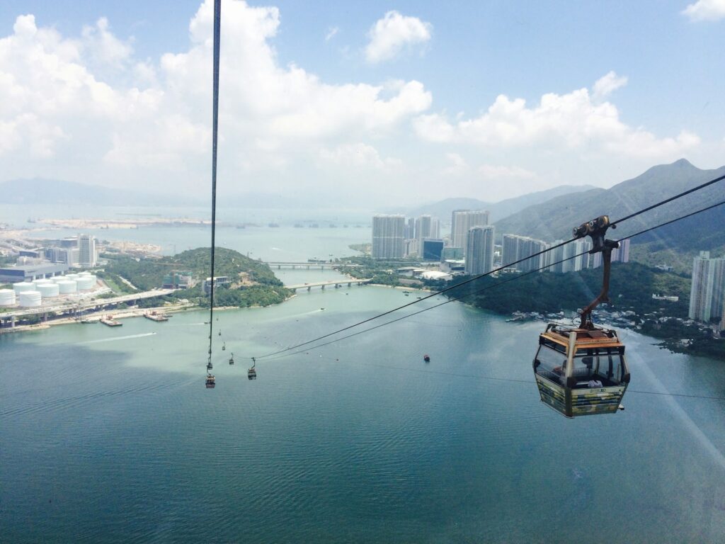 brown boat on body of water near city buildings during daytime